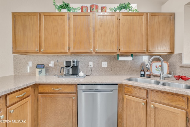 kitchen with dishwasher, light brown cabinetry, tasteful backsplash, and sink