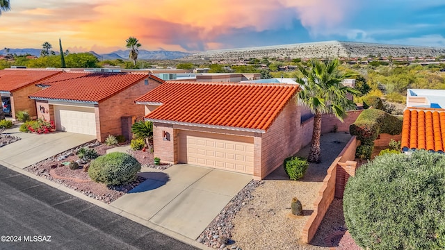 view of front of home with a mountain view and a garage