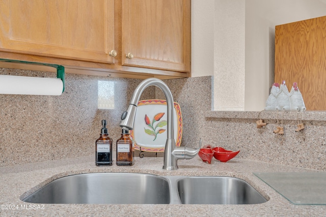 kitchen featuring backsplash, light stone countertops, sink, and light brown cabinets