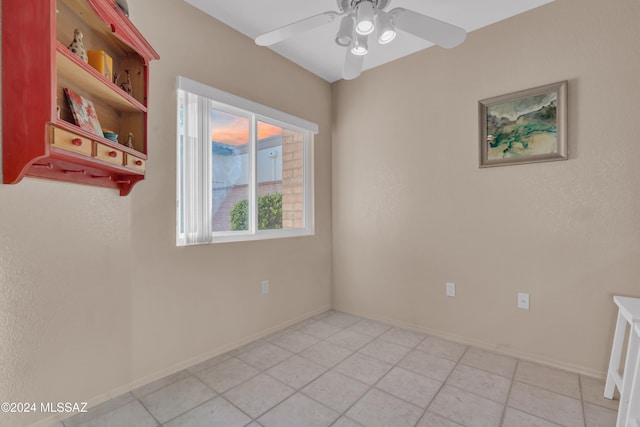 unfurnished room featuring ceiling fan and light tile patterned floors