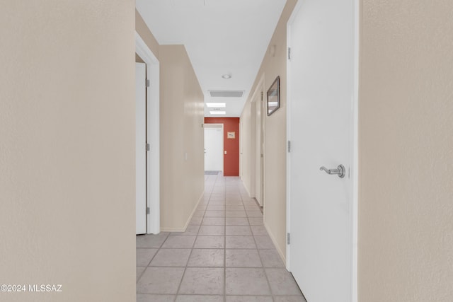 hall with light tile patterned floors