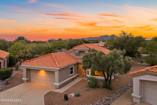 view of front of property with a mountain view and a garage