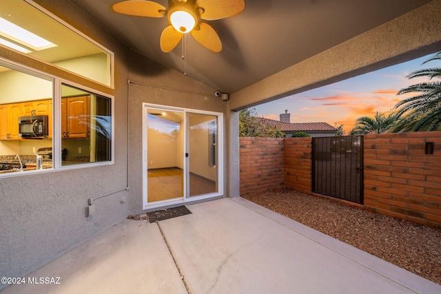 patio terrace at dusk with ceiling fan