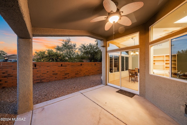 patio terrace at dusk featuring ceiling fan