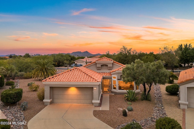 mediterranean / spanish-style home featuring a mountain view and a garage