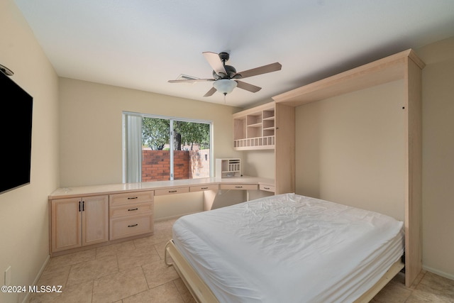 tiled bedroom featuring ceiling fan