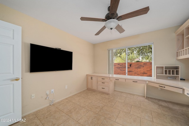 unfurnished office with ceiling fan and light tile patterned floors