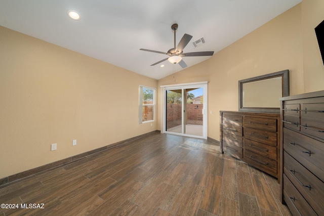 unfurnished bedroom featuring ceiling fan, access to exterior, dark wood-type flooring, and vaulted ceiling