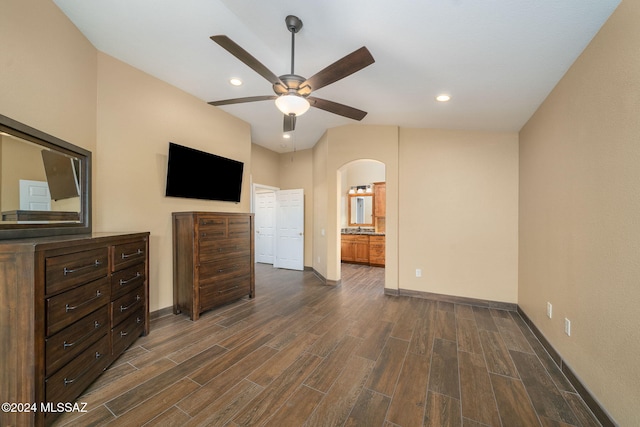 unfurnished bedroom with dark hardwood / wood-style floors, ensuite bath, and ceiling fan