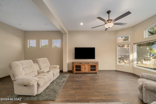 living room featuring ceiling fan and dark wood-type flooring