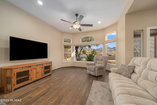 living room featuring ceiling fan and dark hardwood / wood-style flooring