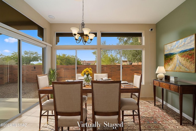 dining area with a chandelier and light tile patterned floors