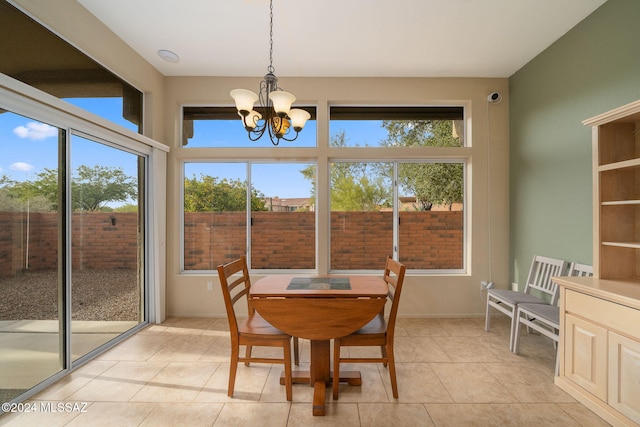 dining area featuring light tile patterned floors and an inviting chandelier