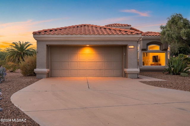 mediterranean / spanish-style house with a garage