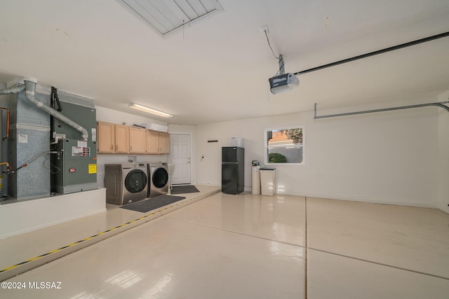 garage with washer and dryer and a garage door opener