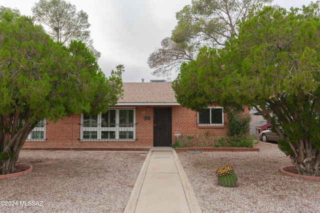 back of property with a carport