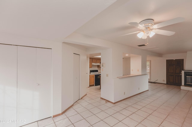 kitchen with light tile patterned floors, black dishwasher, ceiling fan, and sink