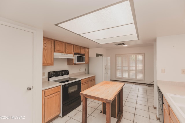 kitchen with dishwasher, light tile patterned floors, and sink