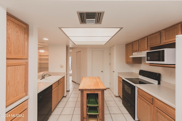 kitchen featuring butcher block counters, light tile patterned floors, and white appliances