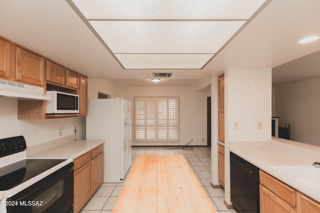 kitchen featuring black electric range oven and light tile patterned flooring