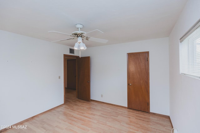 empty room featuring ceiling fan and light hardwood / wood-style flooring