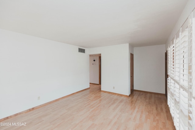 spare room with light hardwood / wood-style flooring