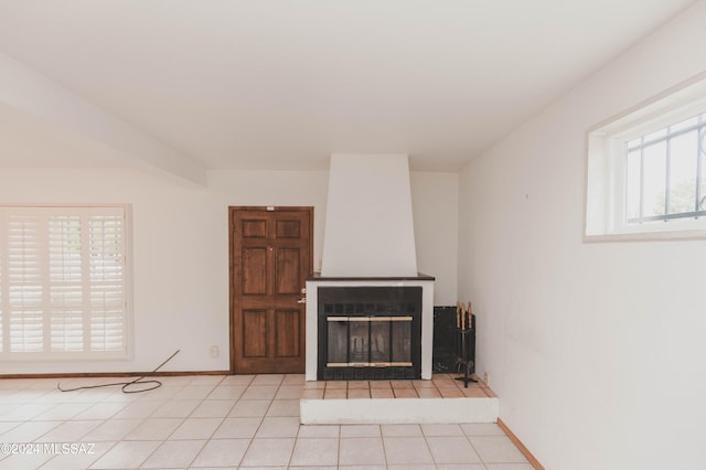 unfurnished living room with ceiling fan and light tile patterned floors