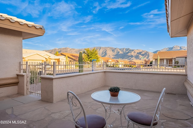 view of patio / terrace with a mountain view and a balcony