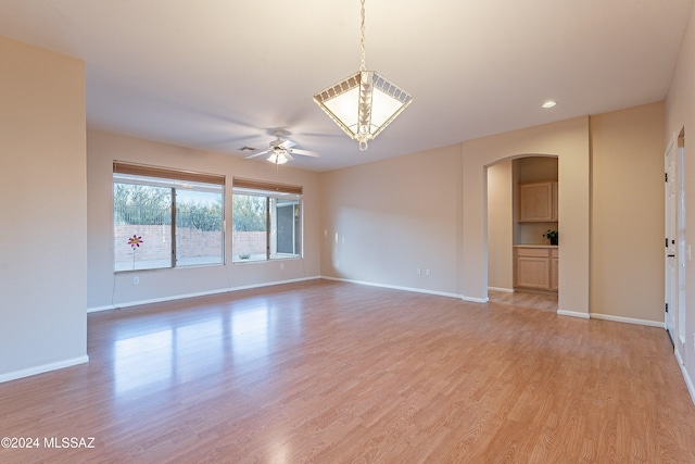 unfurnished room featuring ceiling fan and light hardwood / wood-style floors