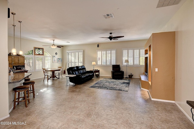 living room featuring ceiling fan and light tile patterned flooring