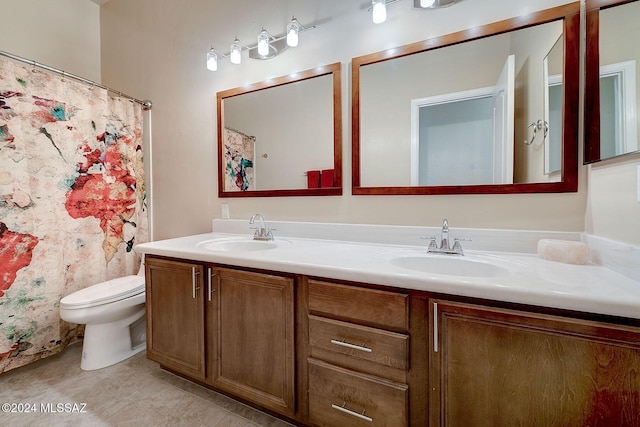 bathroom with toilet, tile patterned floors, and vanity