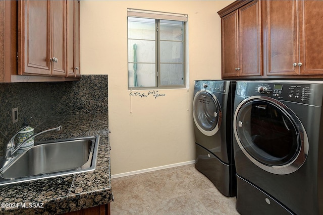 laundry room featuring sink, separate washer and dryer, and cabinets