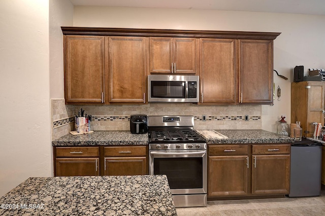 kitchen featuring appliances with stainless steel finishes and tasteful backsplash