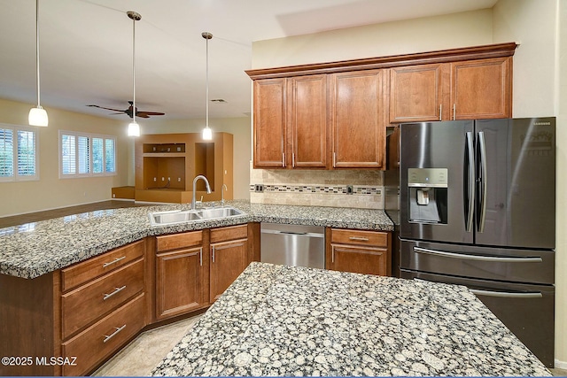 kitchen featuring ceiling fan, decorative light fixtures, decorative backsplash, sink, and appliances with stainless steel finishes