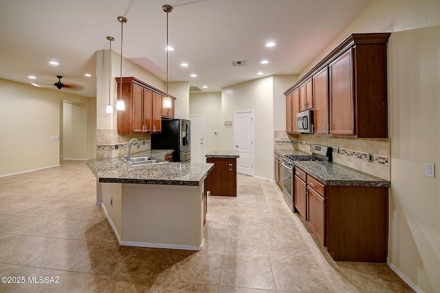 kitchen with pendant lighting, appliances with stainless steel finishes, sink, ceiling fan, and light tile patterned floors