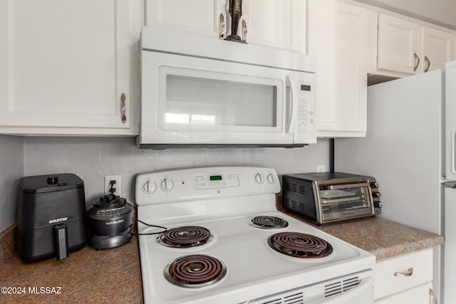 kitchen featuring white cabinets and white appliances