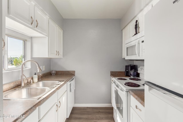 kitchen featuring dark hardwood / wood-style flooring, sink, white cabinets, and white appliances