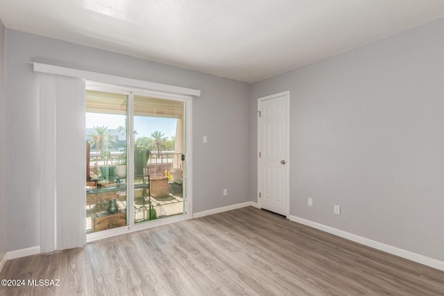 unfurnished room with wood-type flooring