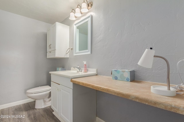 bathroom featuring hardwood / wood-style floors, vanity, and toilet