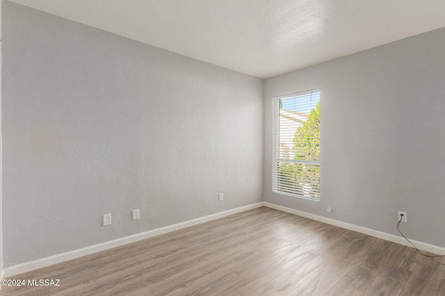 unfurnished room with light hardwood / wood-style flooring