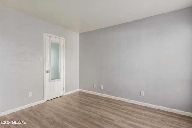 unfurnished room with hardwood / wood-style flooring