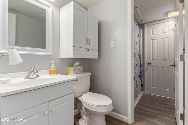 bathroom with vanity, hardwood / wood-style flooring, and toilet