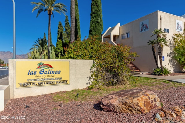 community sign with a mountain view