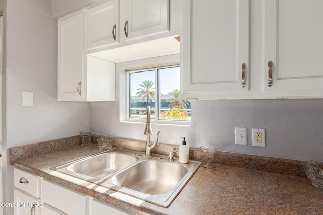 kitchen with white cabinetry and sink