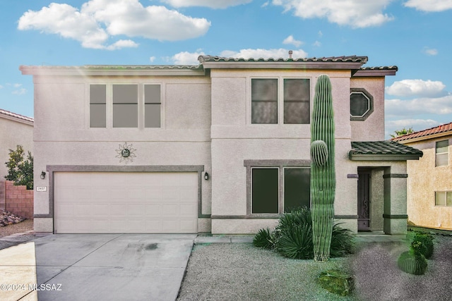 3457 N Crystal Hill Ave, Tucson, AZ 85745 - view of front of home featuring a garage, concrete driveway, a tiled roof, and stucco siding