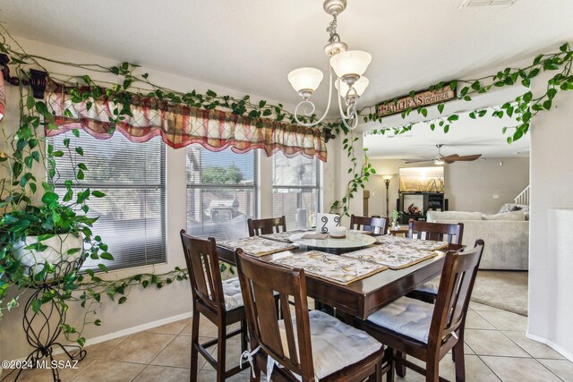 3457 N Crystal Hill Ave, Tucson, AZ 85745 - dining room with light tile patterned floors, a chandelier, baseboards, and ceiling fan