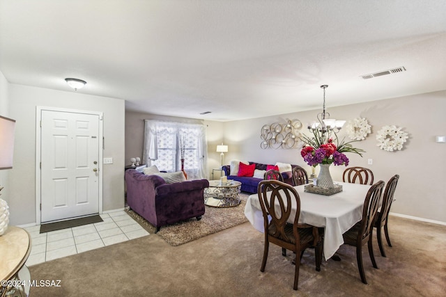 carpeted dining space featuring an inviting chandelier