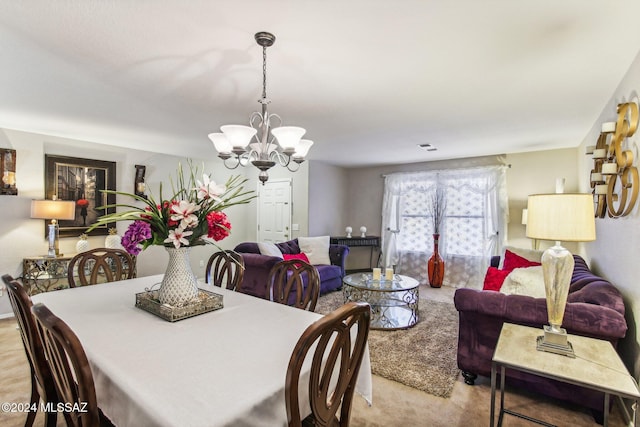 dining room with light carpet and an inviting chandelier