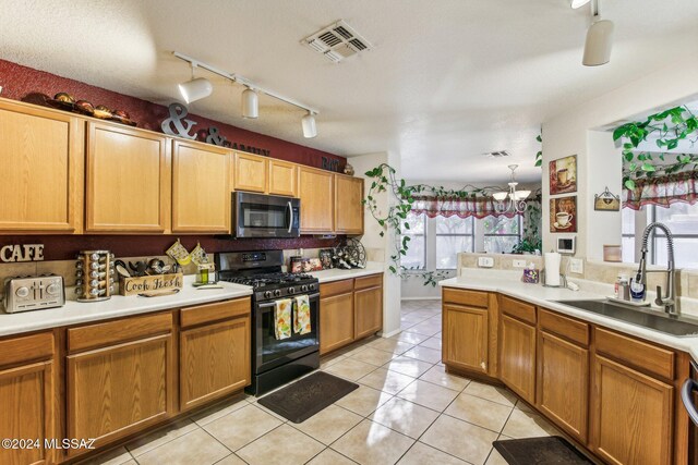 3457 N Crystal Hill Ave, Tucson, AZ 85745 - kitchen featuring range with gas stovetop, a sink, track lighting, light tile patterned floors, and light countertops