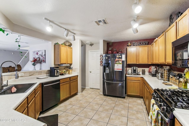 kitchen with black appliances, rail lighting, sink, a textured ceiling, and light tile patterned flooring